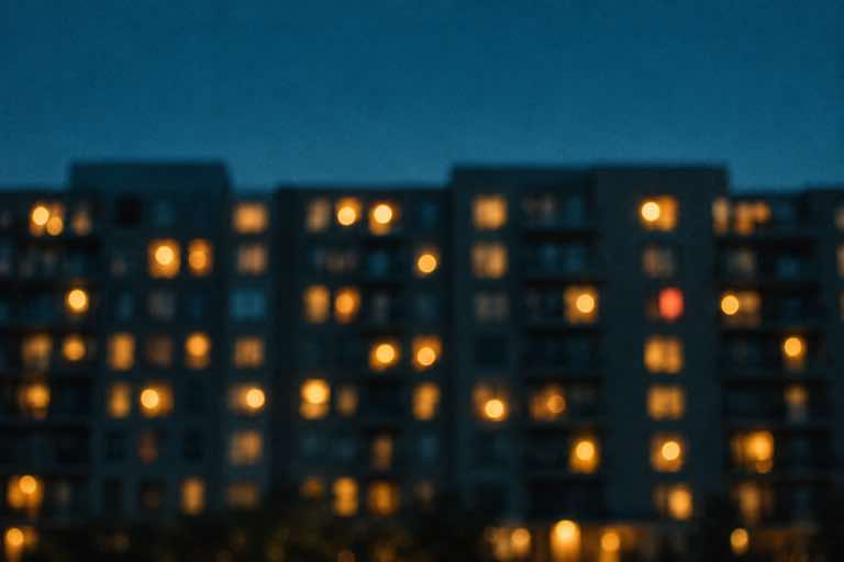 Apartment windows glowing at dusk